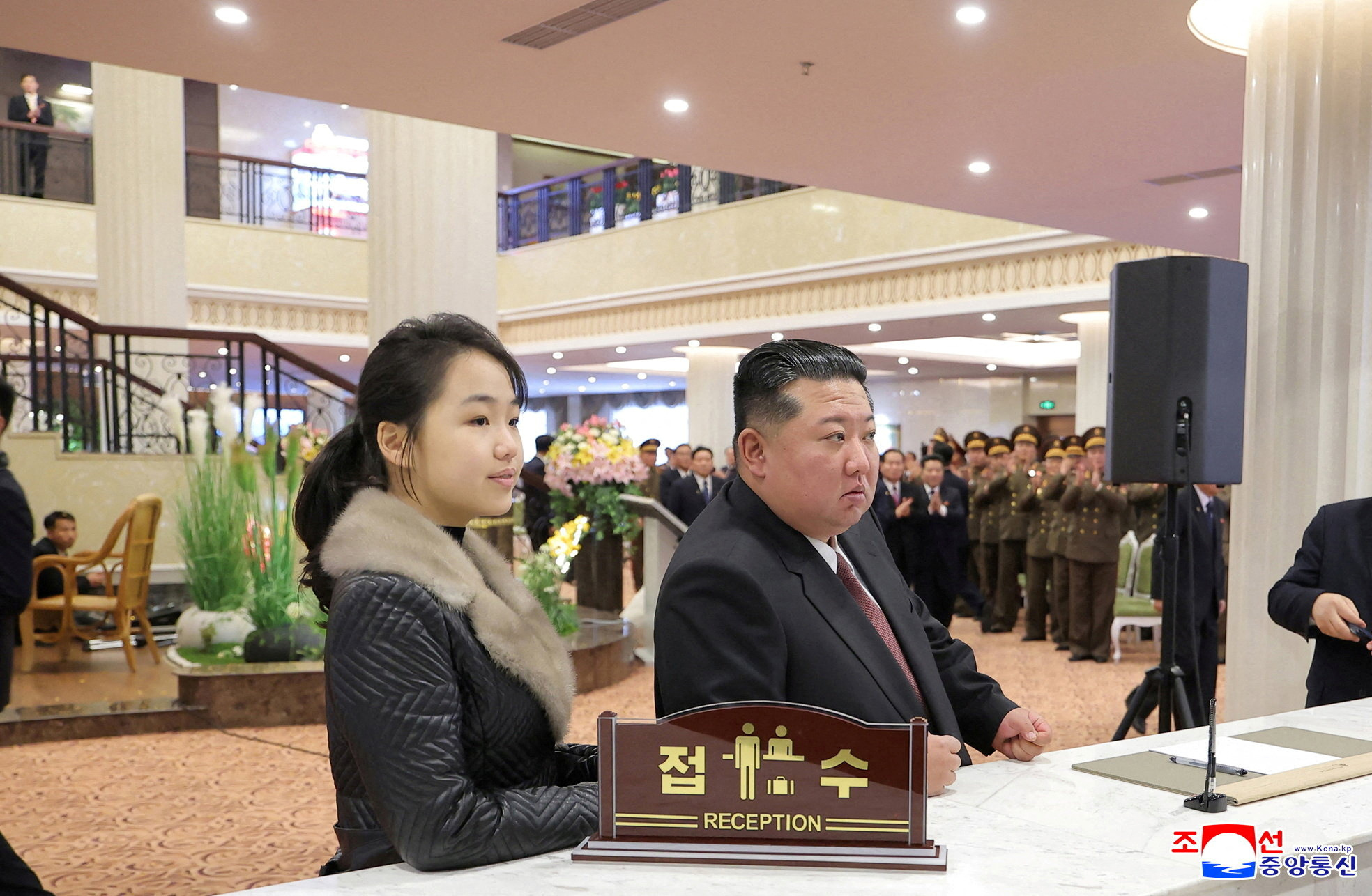 FILE PHOTO: North Korean leader Kim Jong Un and his daughter Kim Ju Ae stand at a hotel reception counter as they attend an inauguration ceremony for hotels in the tourist resort in Samjiyon City
