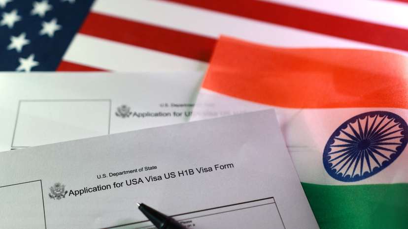 Illustration shows U.S. and Indian flags, U.S. H-1B Visa application forms
