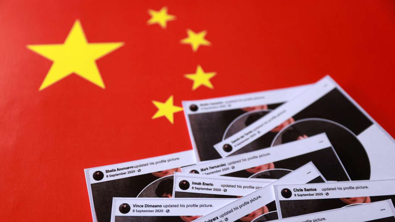 Illustration shows cut-outs of posts from fake Facebook profiles placed on a Chinese flag