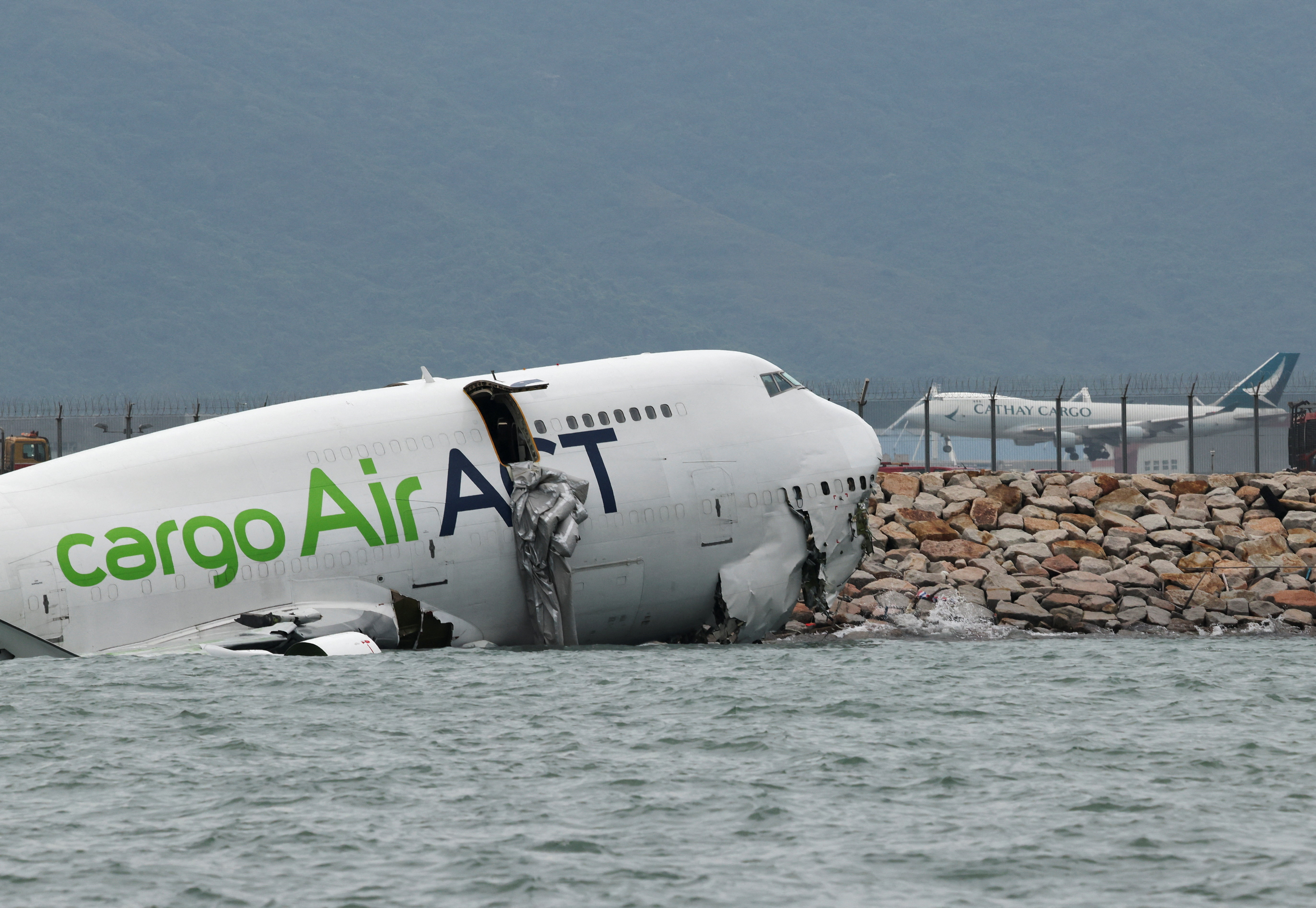 A cargo plane skids off the runway during landing at Hong Kong International Airport