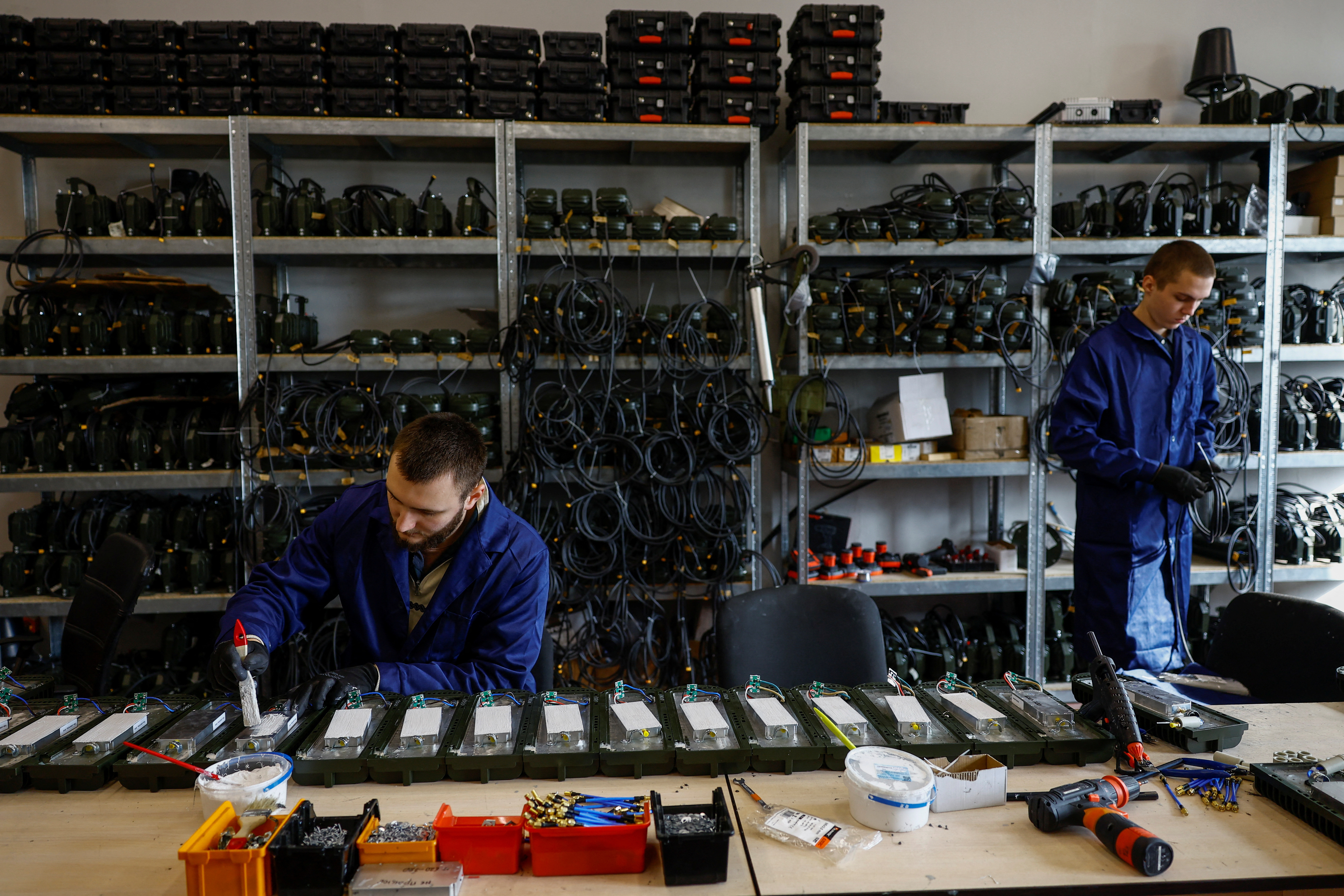 Employees work at a production facility of a Ukrainian producer of jammers and radio electronic warfare in an undisclosed location in Ukraine