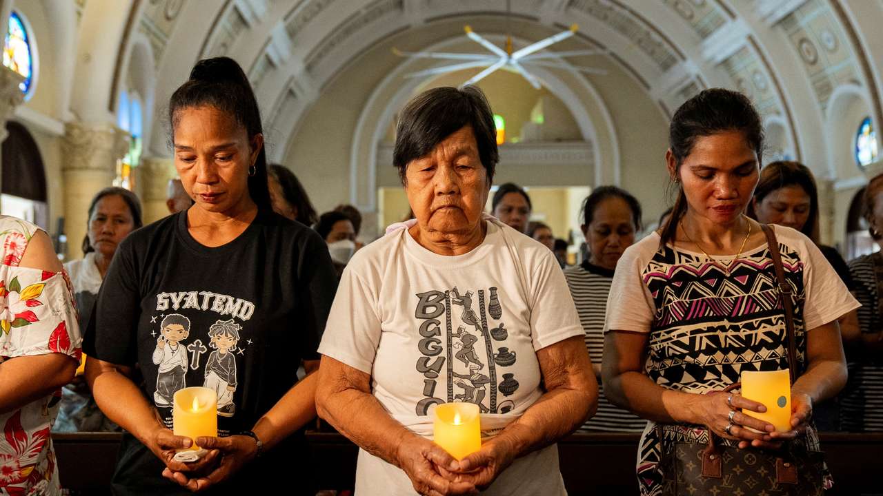 Relatives of victims of drug war and extrajudicial killings gather during a mass, in Quezon City