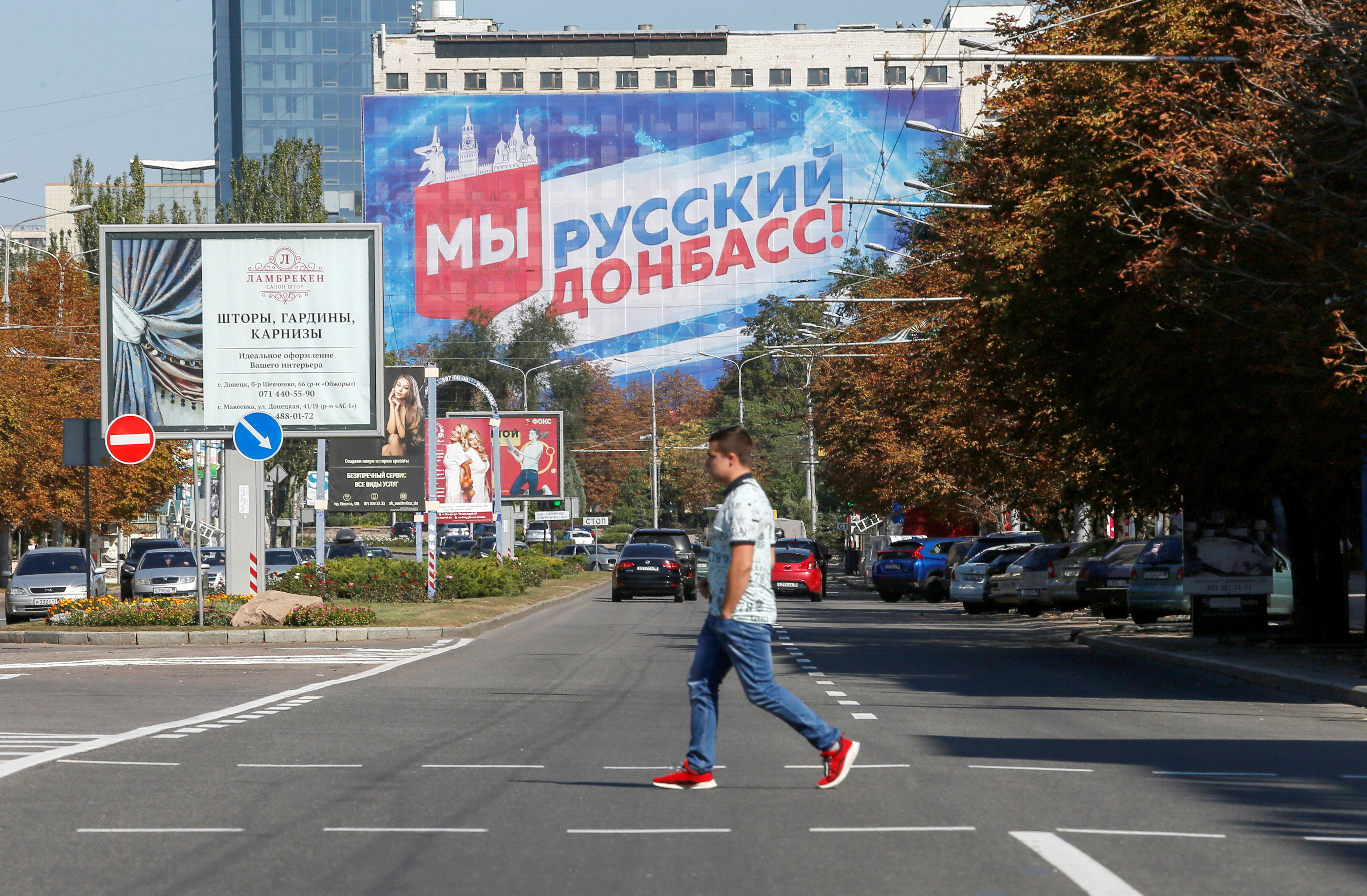 A pedestrian crosses a street in the rebel-held city of Donetsk