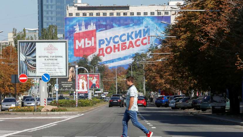 A pedestrian crosses a street in the rebel-held city of Donetsk