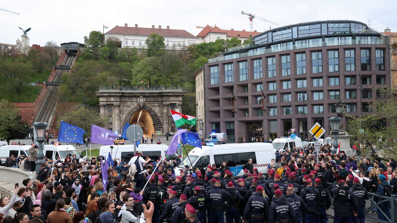Police officers gather as protesters attend a demonstration after the Hungarian parliament voted on constitutional amendments targeting the LGBTQ community, at the Chain Bridge, as the presidential Sandor Palace is seen in the distance, in Budapest, Hungary, April 14, 2025. REUTERS/Bernadett Szabo