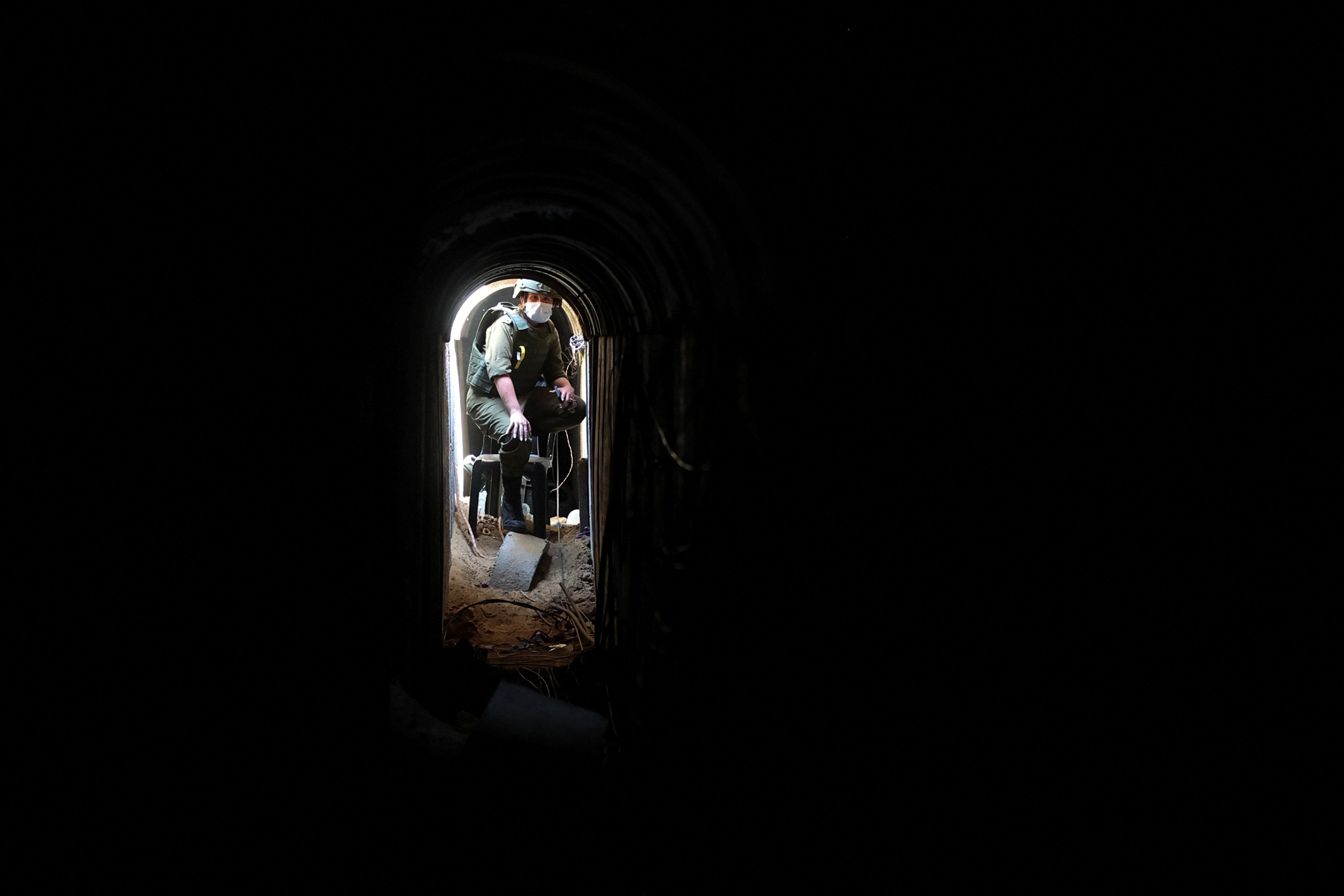 An Israeli soldier sits inside a tunnel underneath the European Hospital in Khan Younis at the Gaza Strip