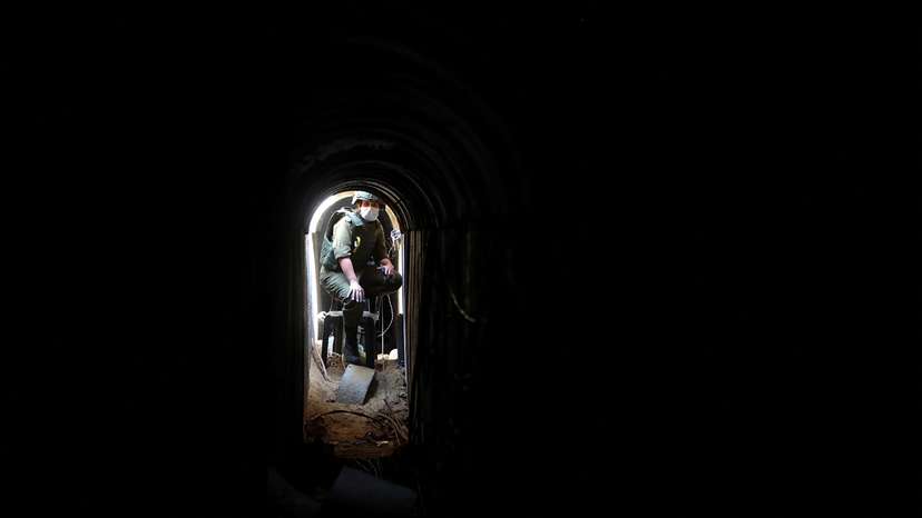 An Israeli soldier sits inside a tunnel underneath the European Hospital in Khan Younis at the Gaza Strip