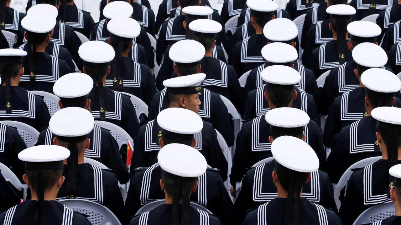 Chinese navy personnel attend an event celebrating the 70th anniversary of the founding of the Chinese People's Liberation Army Navy (PLAN) in Qingdao
