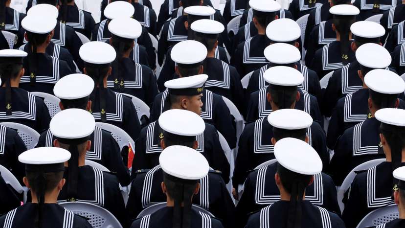 Chinese navy personnel attend an event celebrating the 70th anniversary of the founding of the Chinese People's Liberation Army Navy (PLAN) in Qingdao