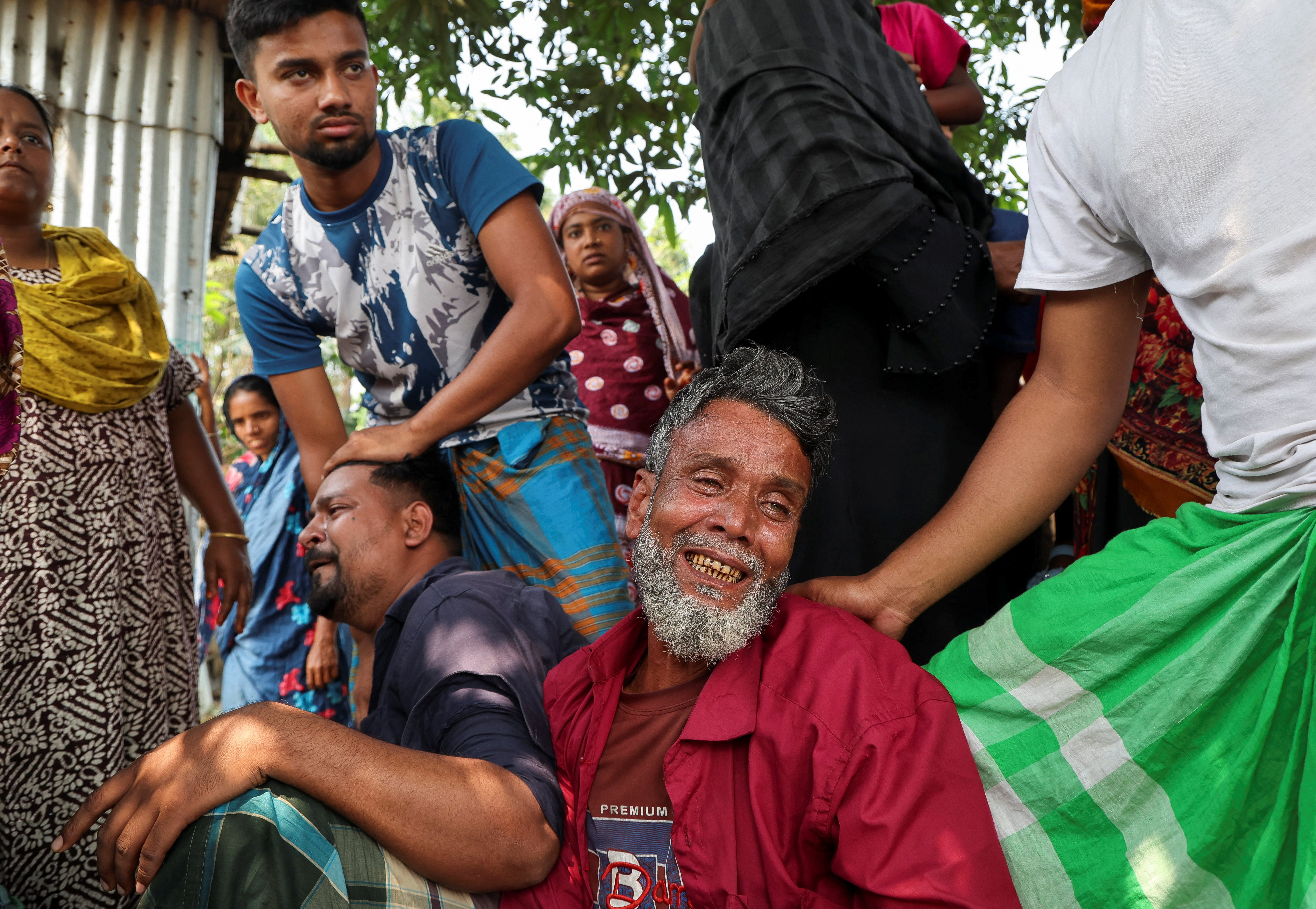 Relatives of a victim mourn after a bus plunged into the Padma River while attempting to board a ferry in Rajbari