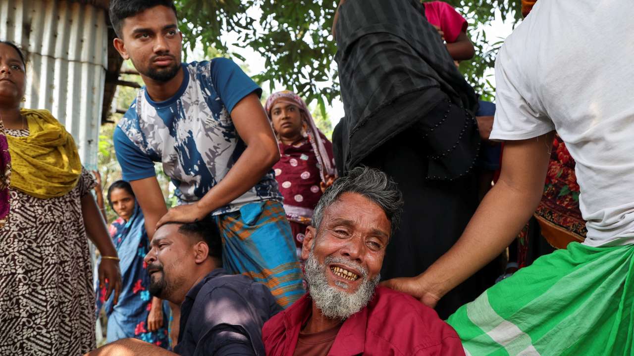 Relatives of a victim mourn after a bus plunged into the Padma River while attempting to board a ferry in Rajbari