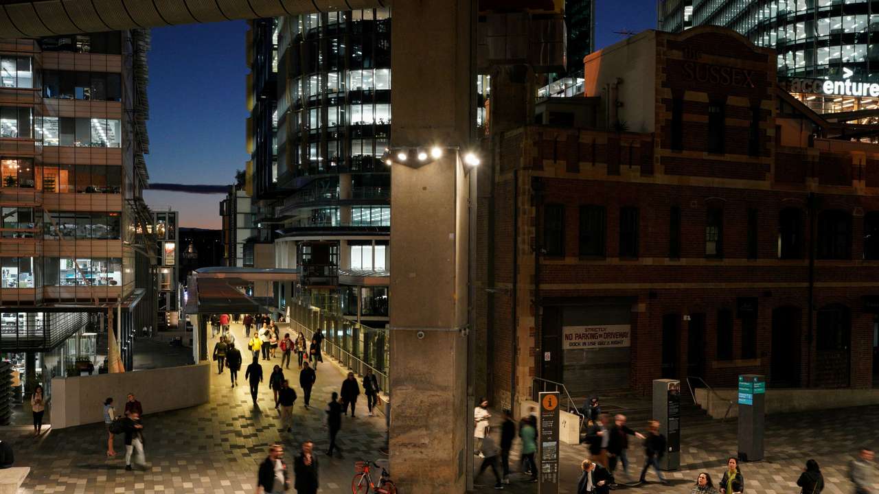 FILE PHOTO: People walk through the Central Business District (CBD) at dusk in Sydney