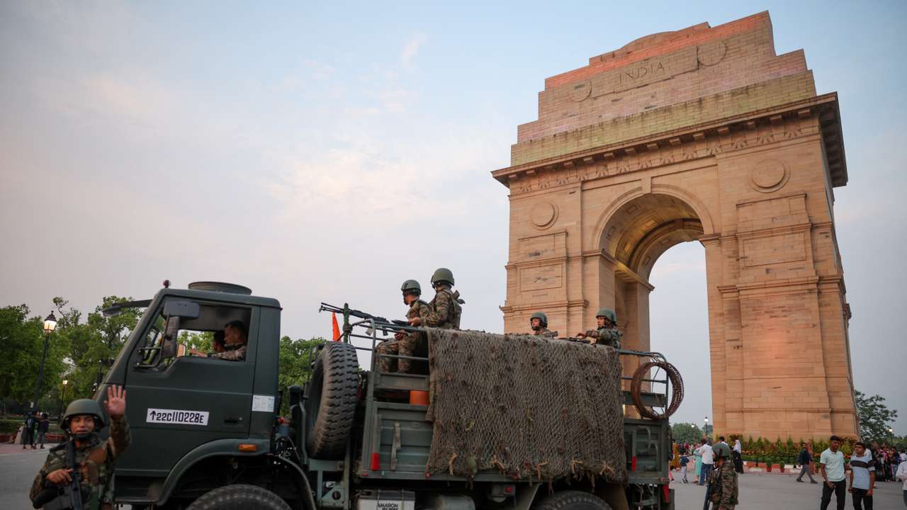 Military personnel with Indian Army stand guard at India Gate in New Delhi