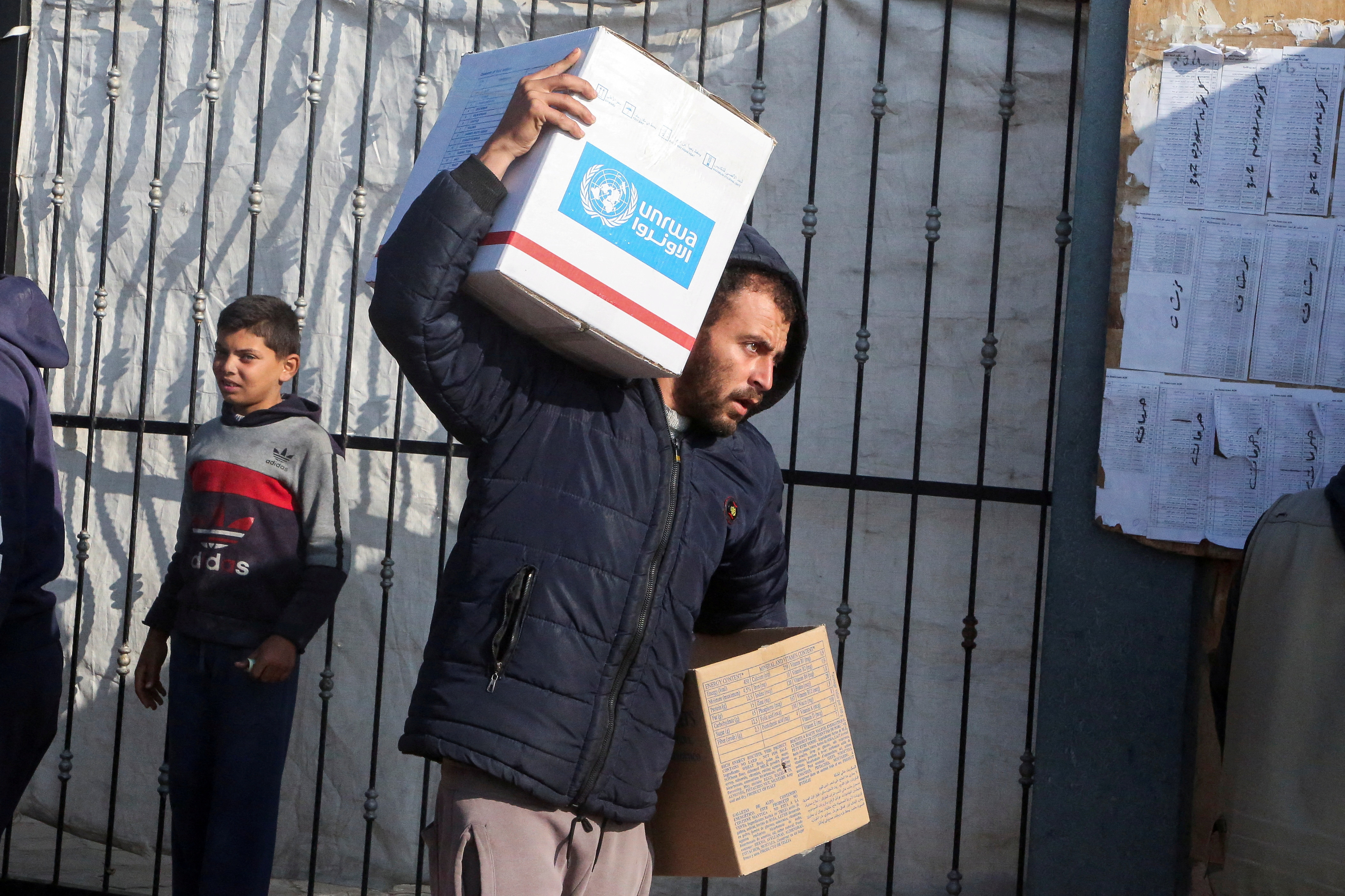 FILE PHOTO: Palestinians receive aid from UNRWA in Khan Younis in the southern Gaza Strip