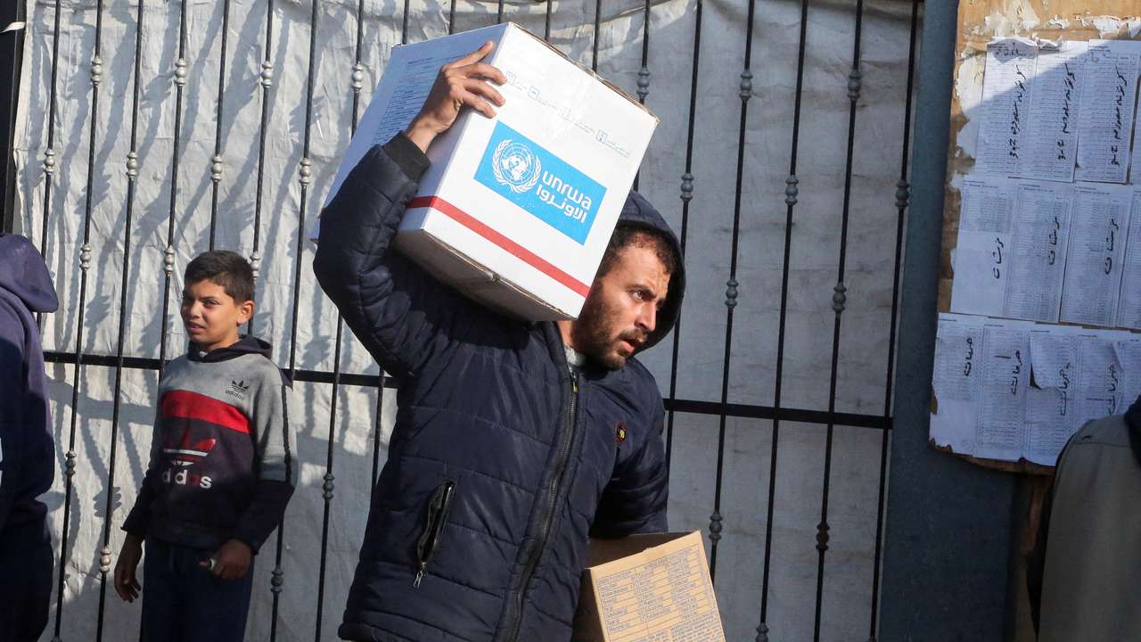 FILE PHOTO: Palestinians receive aid from UNRWA in Khan Younis in the southern Gaza Strip