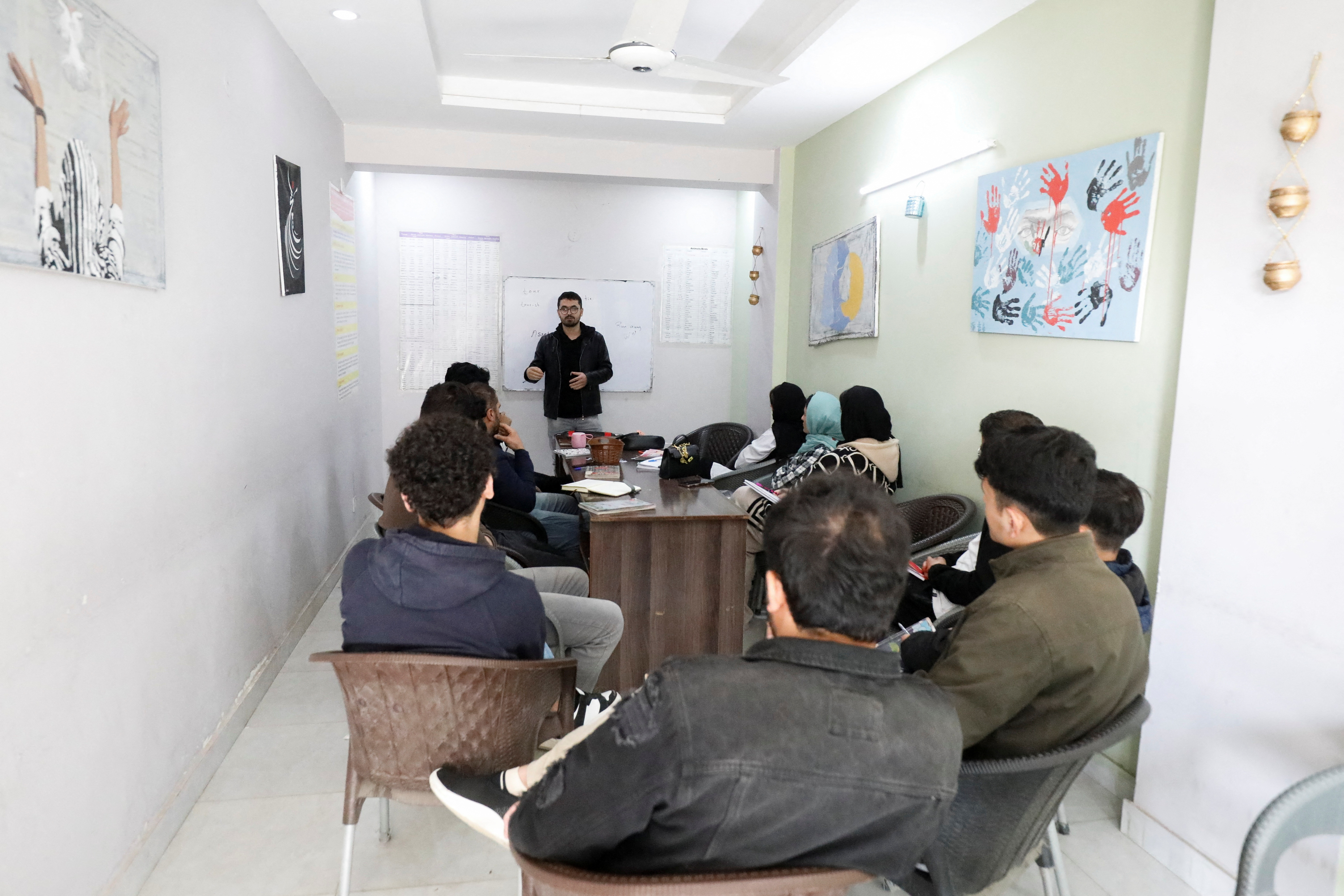 Afghan citizens, who are in the process for resettlement in the U.S. attend English language class on the outskirts of Islamabad