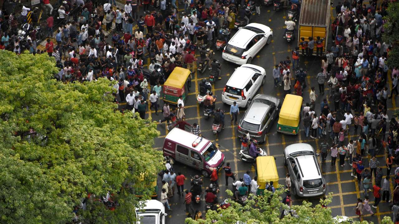 An ambulance moves following a stampede outside a cricket stadium in Bengaluru