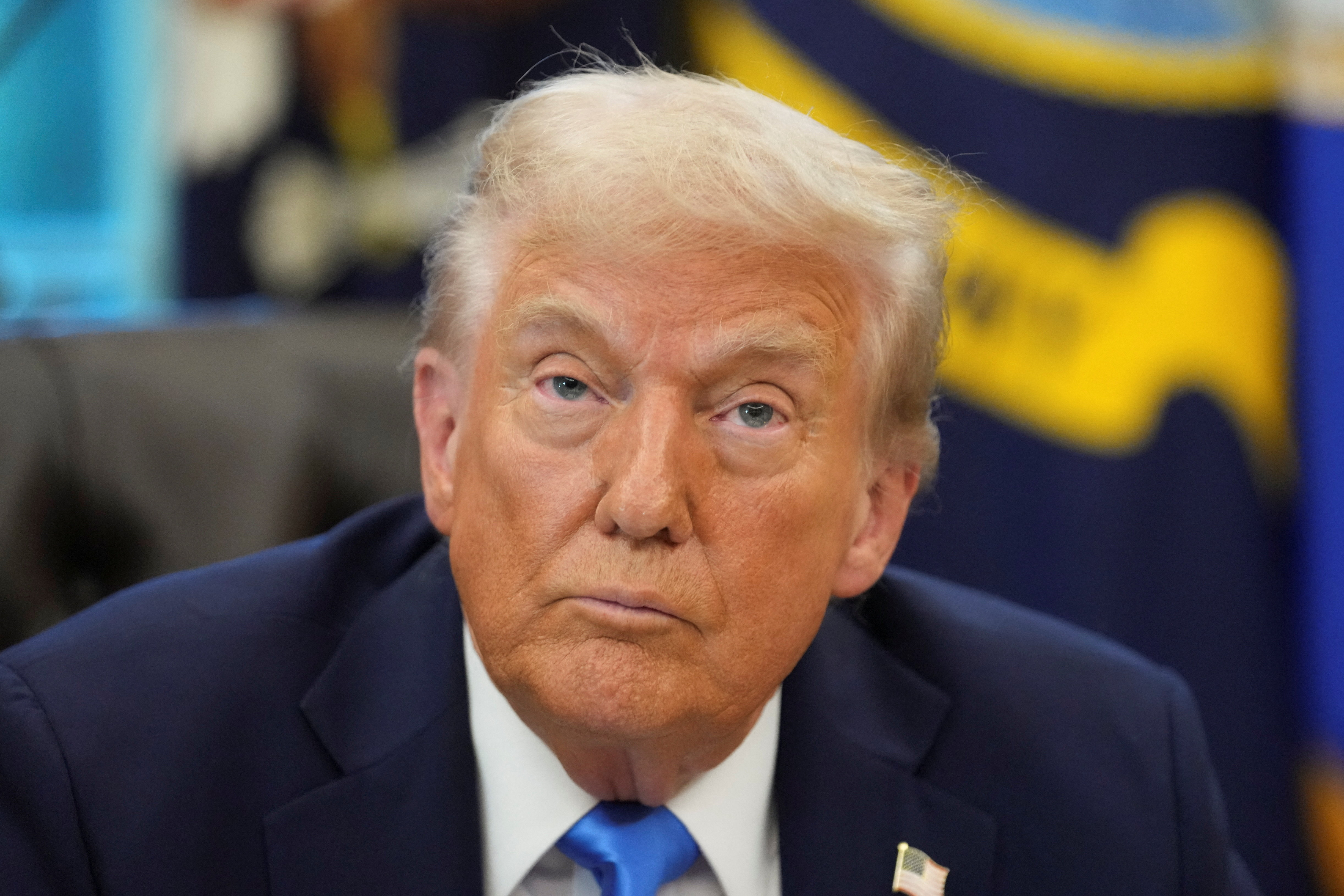 U.S. President Donald Trump signs executive orders in the Oval Office at the White House in Washington