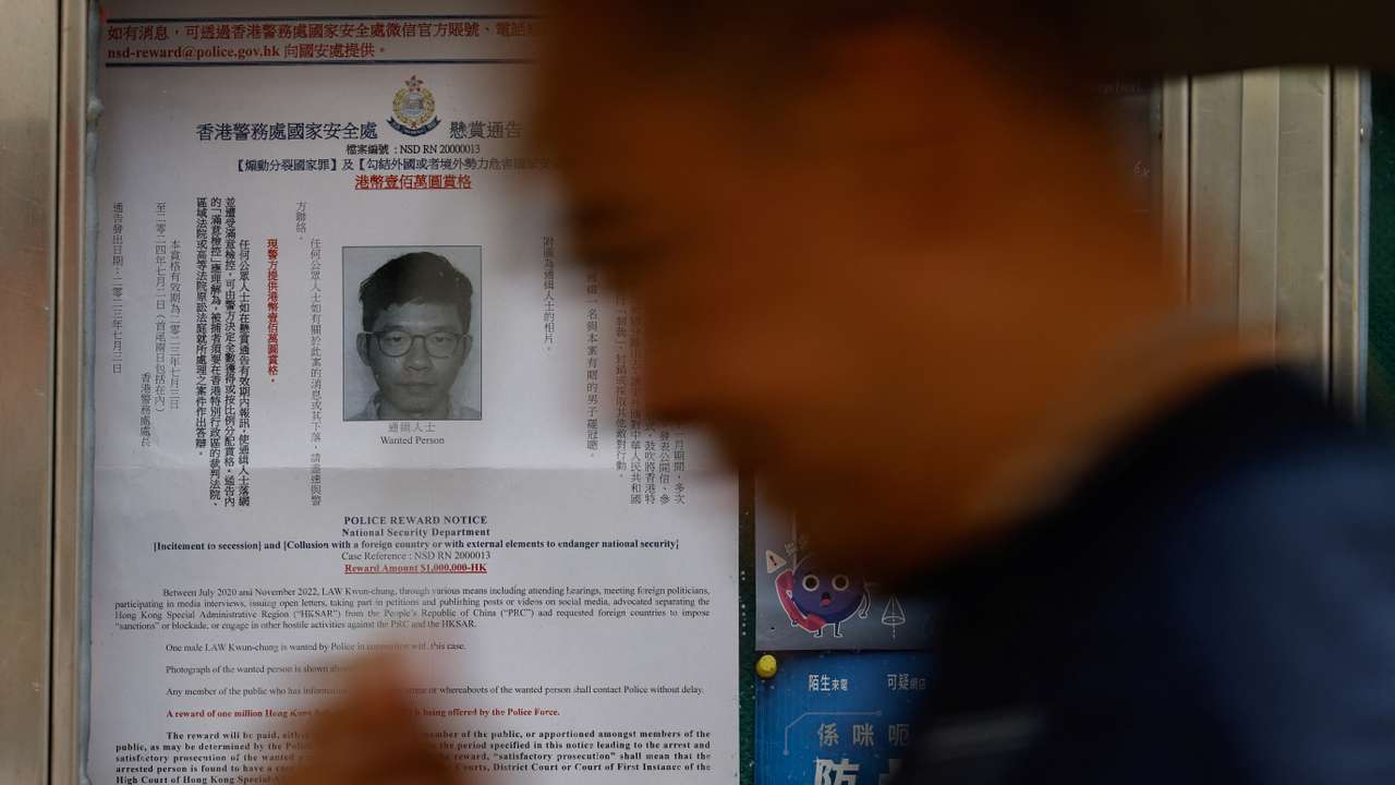 A profile of wanted exiled activist Nathan Law, is seen on a noticeboard outside a police station in Hong Kong