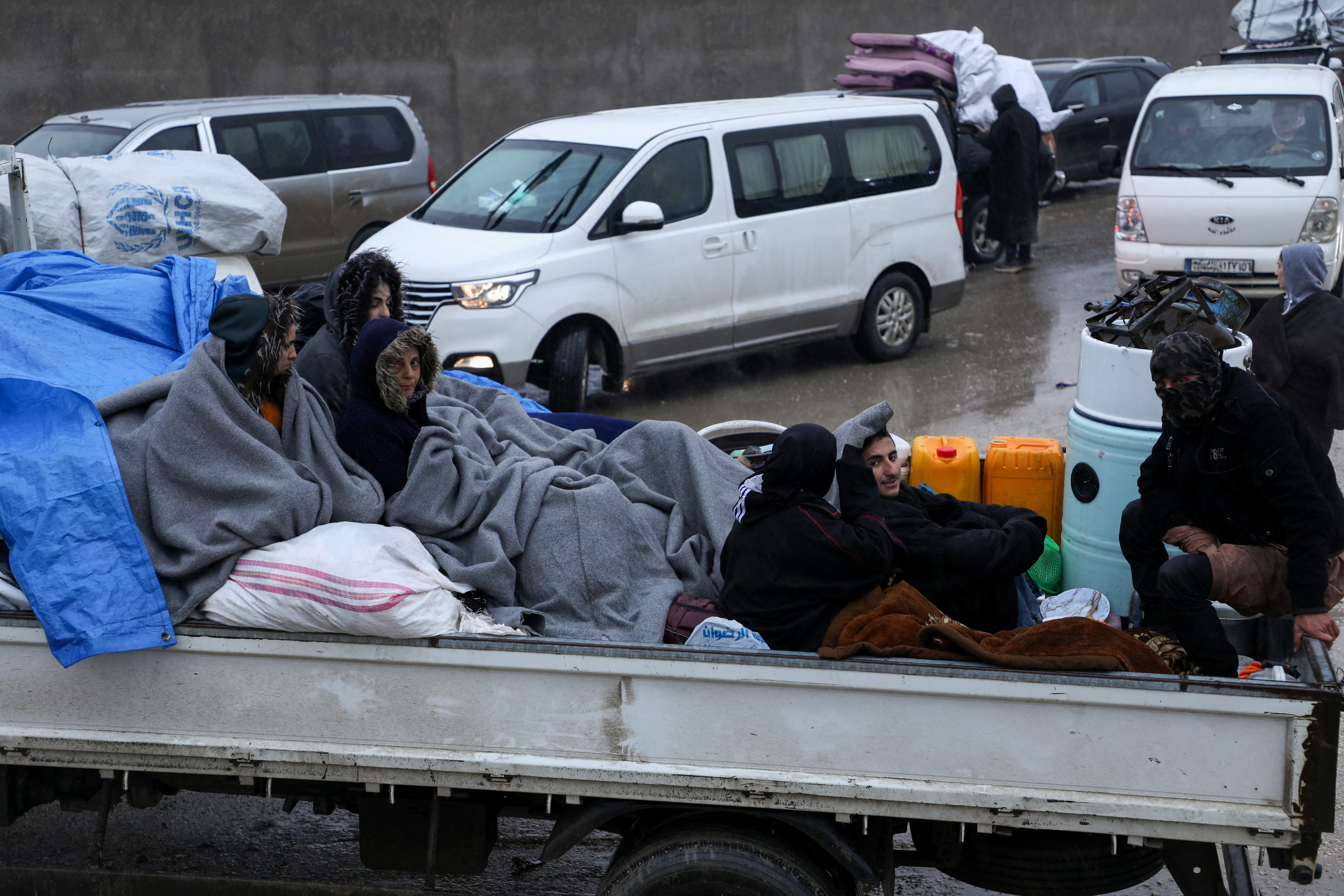 FILE PHOTO: Civilians flee Tabqa after clashes between SDF and Syrian army, in Hasakah