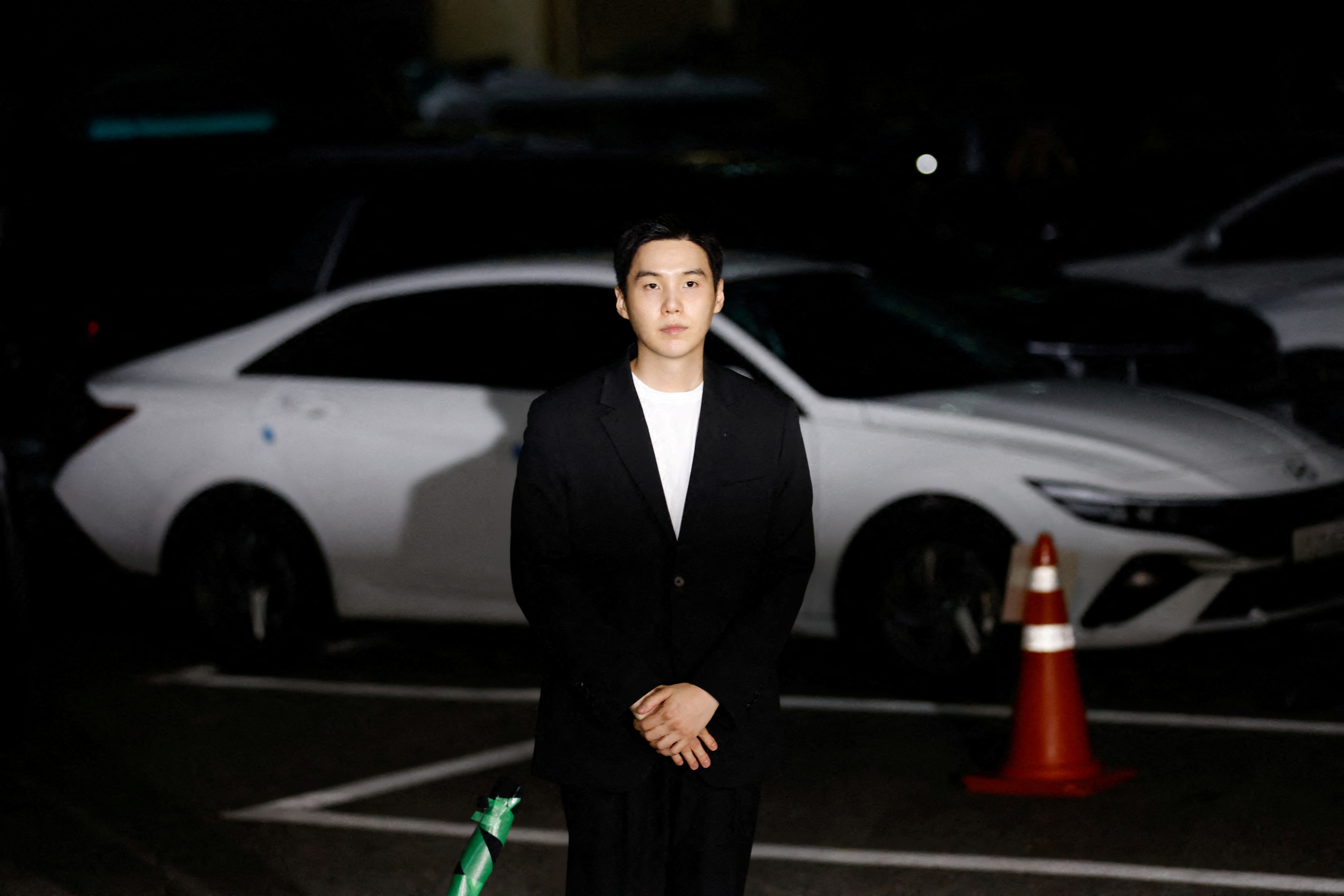 FILE PHOTO: Suga of the K-pop boy band BTS arrives at a police station for questioning regarding his drunk driving charge, in Seoul