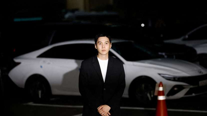 FILE PHOTO: Suga of the K-pop boy band BTS arrives at a police station for questioning regarding his drunk driving charge, in Seoul