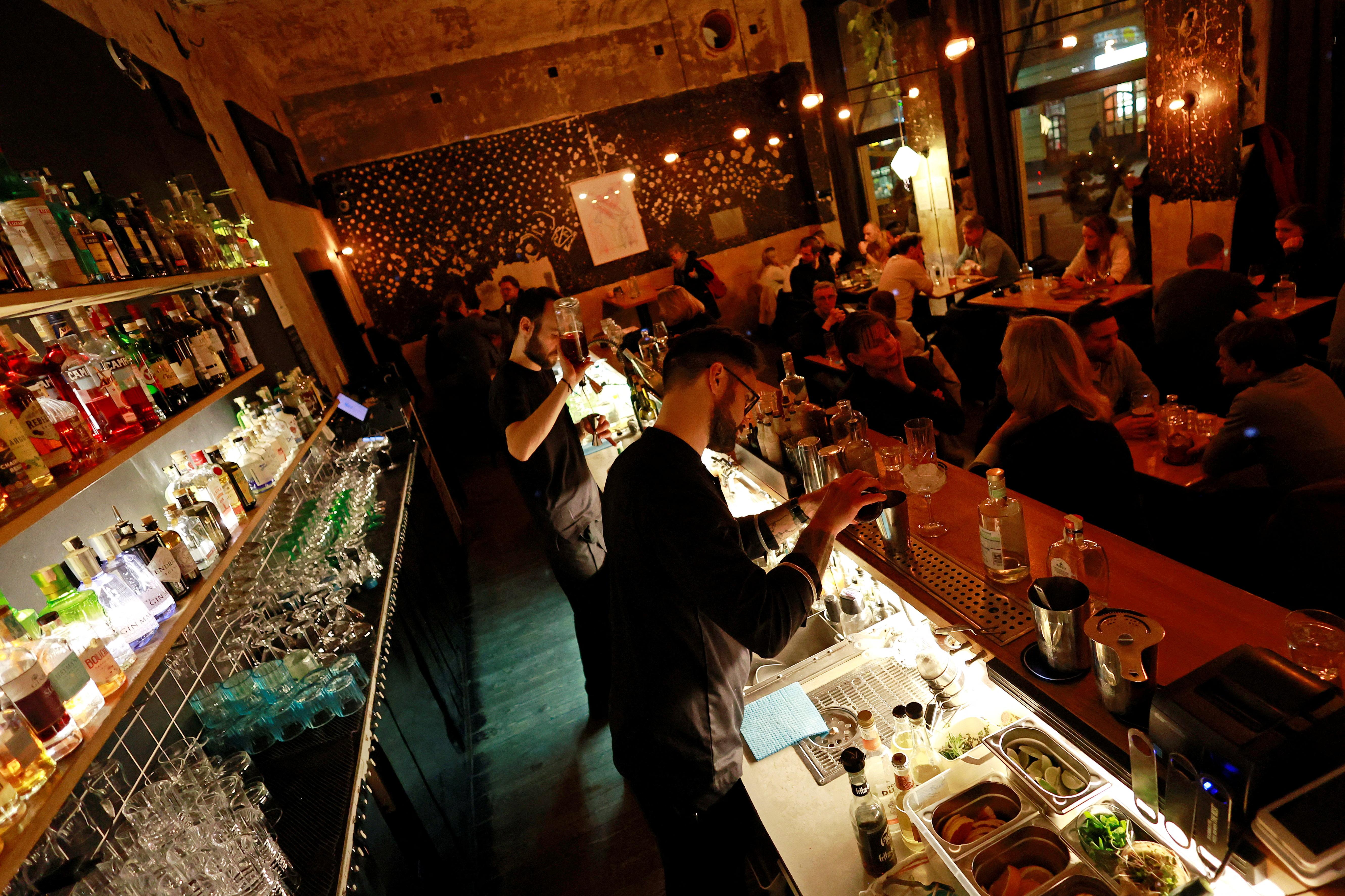 Bartenders prepare drinks at the Cobra bar in Prague