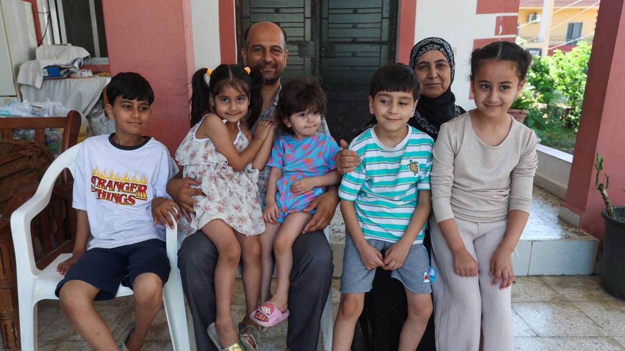 Samer Abu Della, displaced Lebanese from southern border village of Yarine, poses for a picture with his mother Adibeh, and children in Baisariyeh