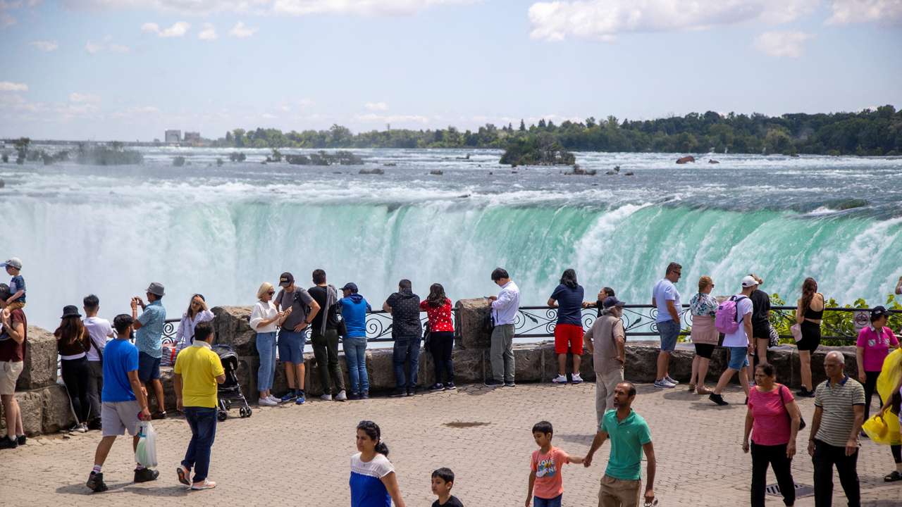 FILE PHOTO: Tourist take photos in front of the Horsehoe Falls in Niagara Falls