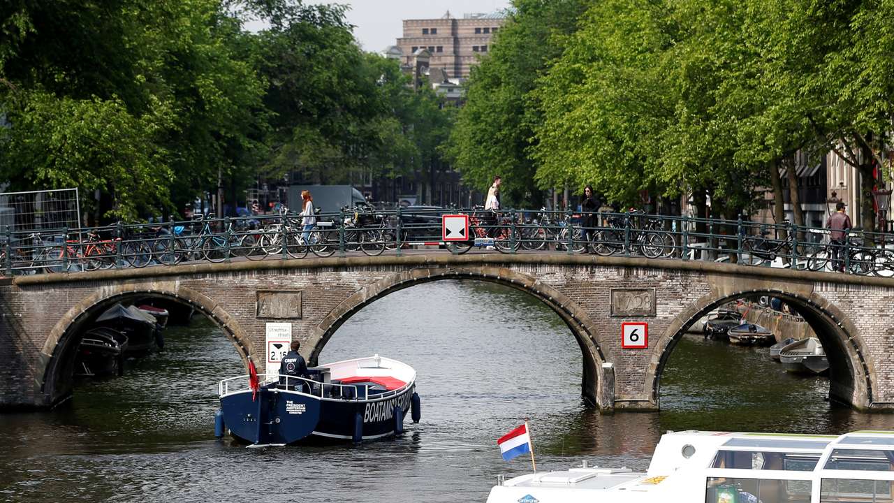 Tourists boats pass on a canal in Amsterdam