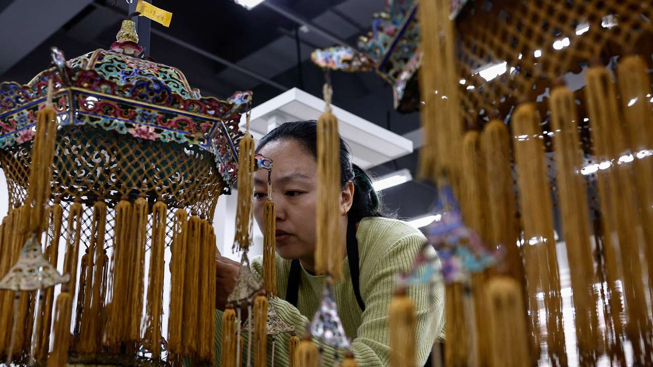 A conservator restores a cultural relic at the Forbidden City, in Beijing