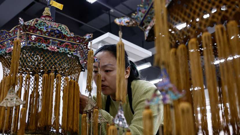 A conservator restores a cultural relic at the Forbidden City, in Beijing