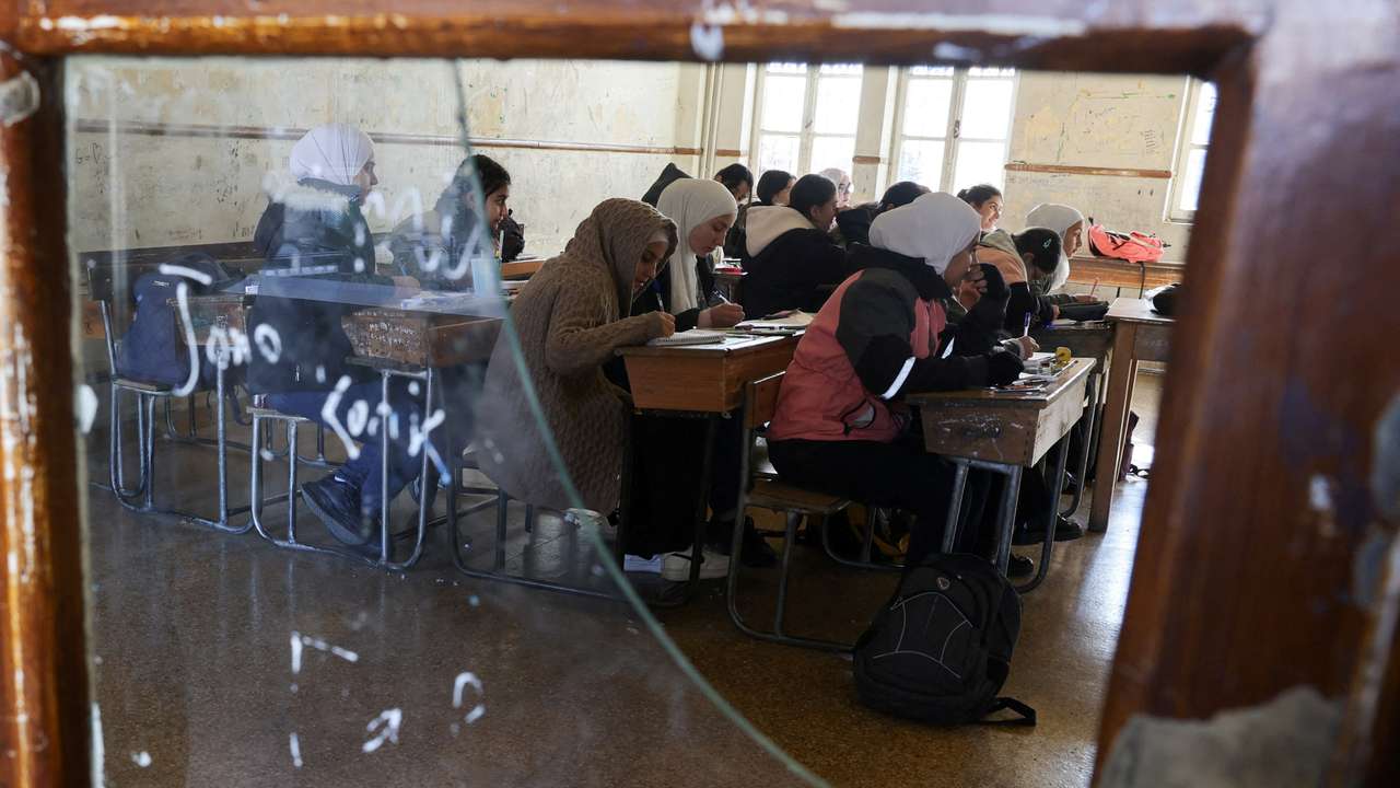 Students in a classroom after authorities announced the reopening of schools, in Damascus
