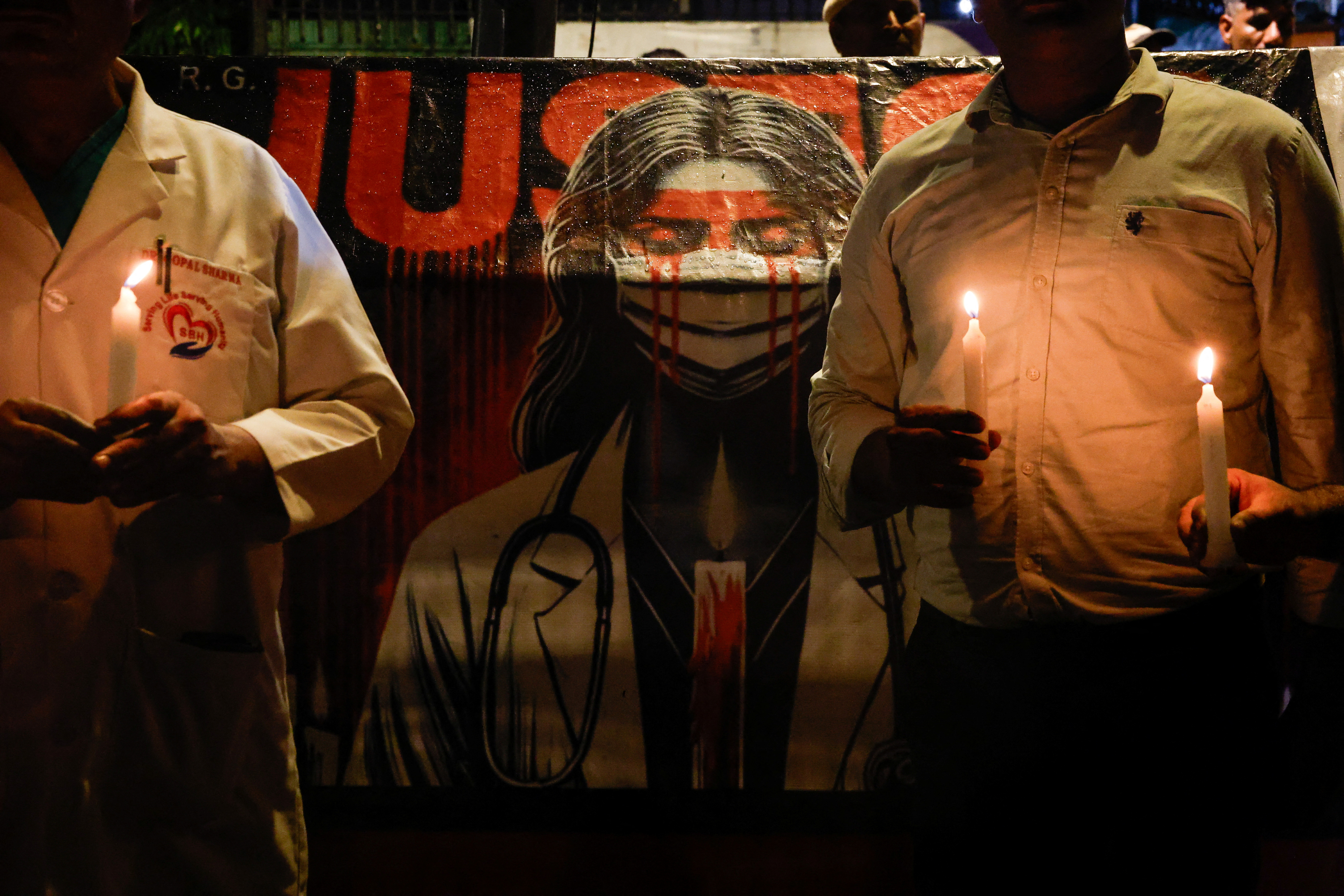 FILE PHOTO: Doctors hold candles during a protest rally in New Delhi