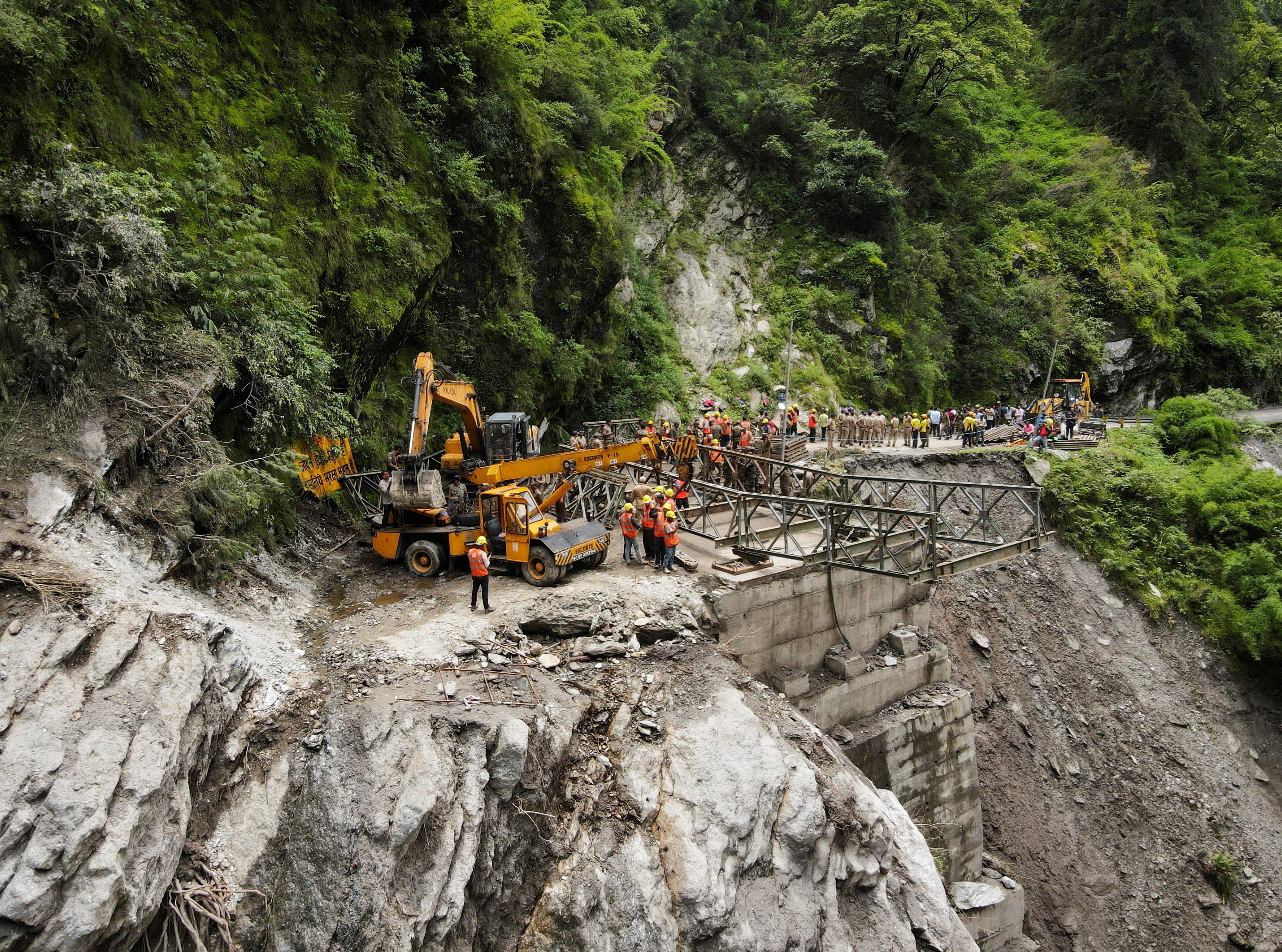 A drone view of BRO and SDRF officials attempting to build a makeshift bridge in Gangnani