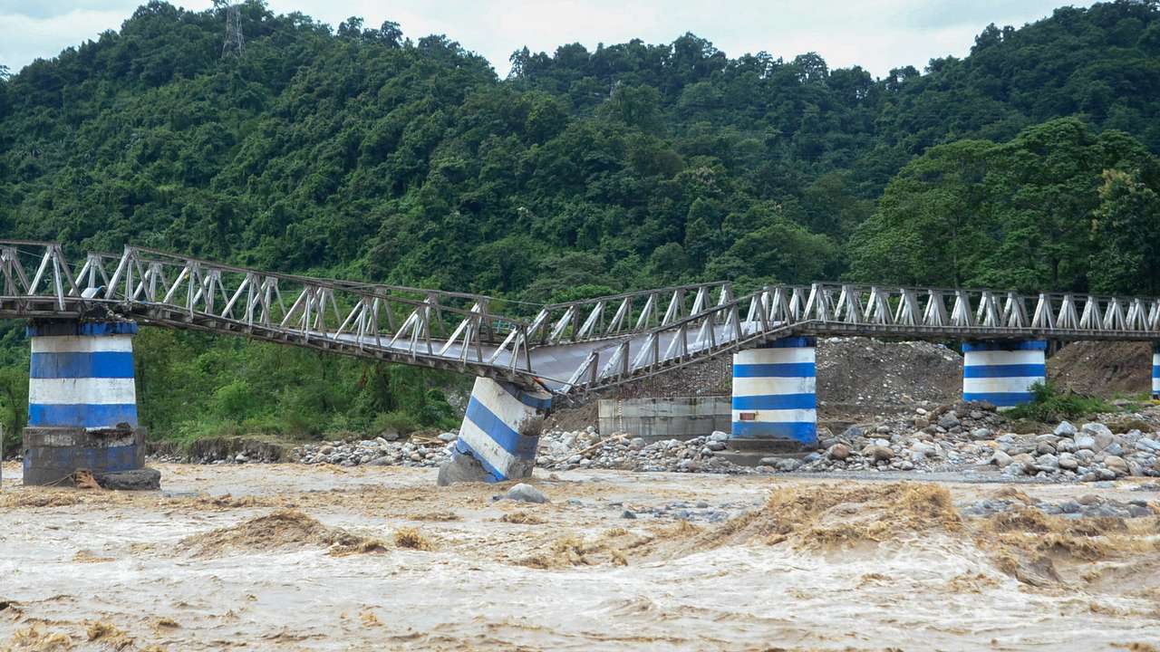 The collapsed Dudhia Iron Bridge over the Balason River after torrential rains in Darjeeling