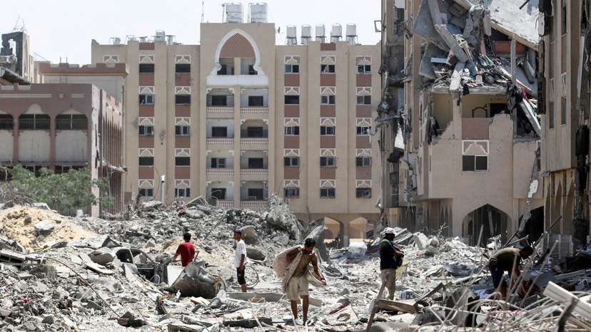 Palestinians inspect damage in Qatari-funded Hamad City, in Khan Younis