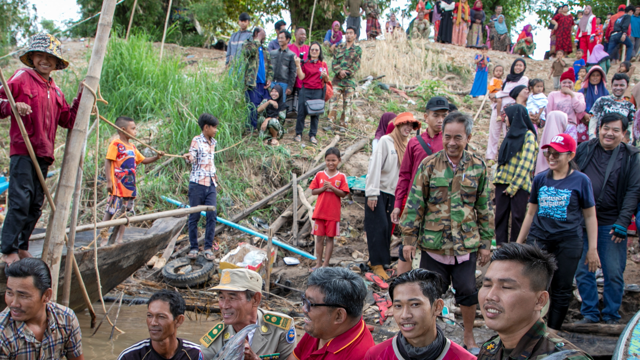 Scientists, officials and fishermen release a 300-pound giant freshwater catfish after it was tagged, into the Mekong River, near Kampong Cham province