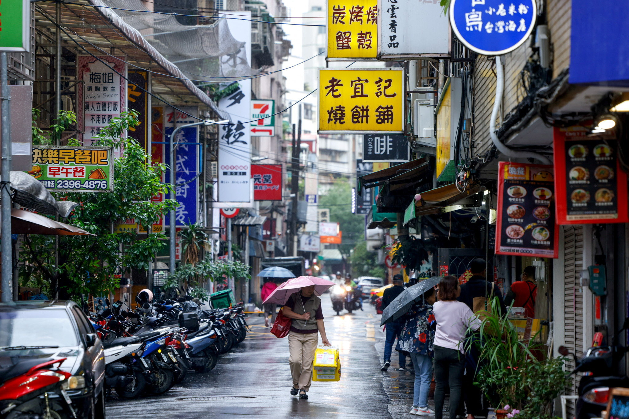 A person holds an umbrella as Typhoon Fung-wong approaches in Taipei