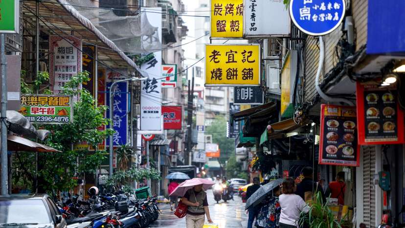 A person holds an umbrella as Typhoon Fung-wong approaches in Taipei