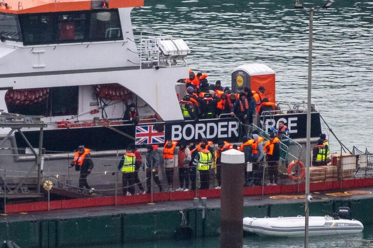 Migrants arrive in the UK after crossing the English Channel