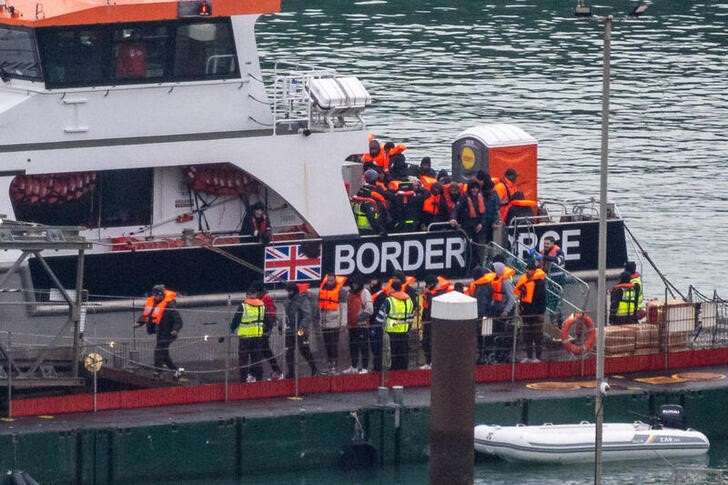 Migrants arrive in the UK after crossing the English Channel