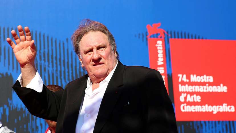 FILE PHOTO: Gerard Depardieu waves as he arrives during a red carpet event for the movie "Novecento- Atto Primo" at the 74th Venice Film Festival in Venice
