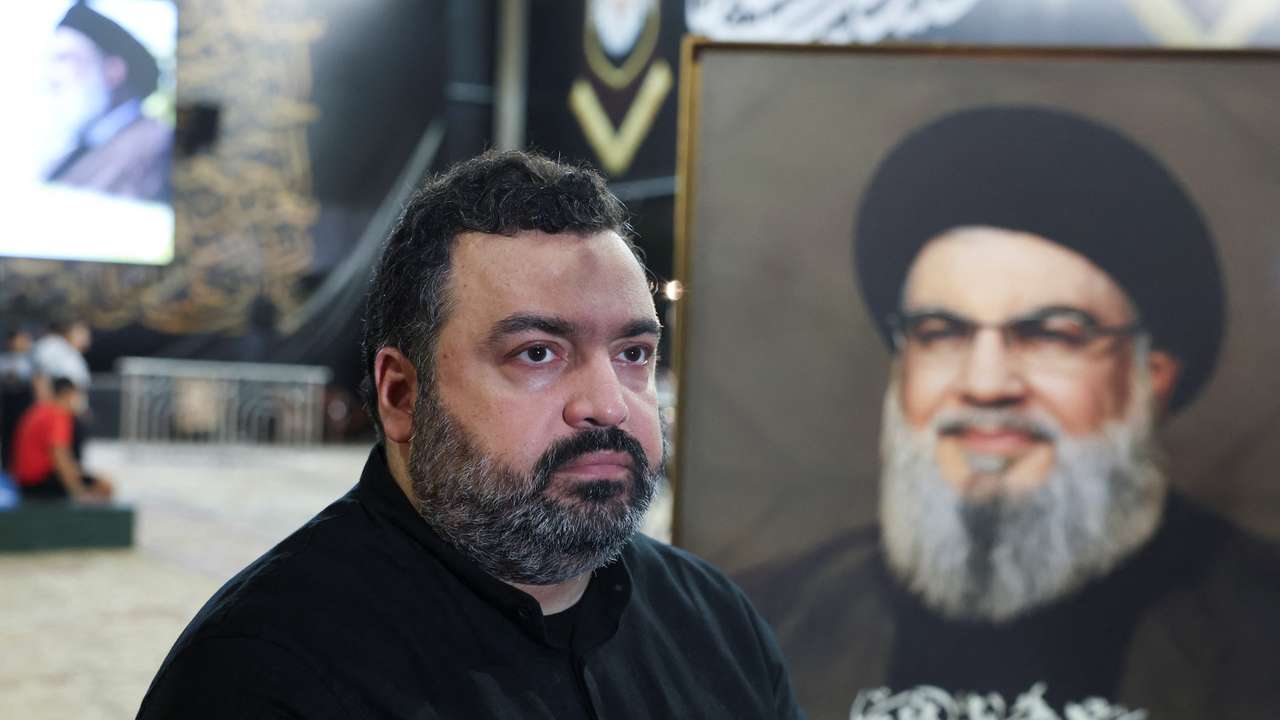 Jawad Nasrallah, son of late Hezbollah leader Hassan Nasrallah, sits at the burial site ahead of the first anniversary of his father's assassination, on the outskirts of Beirut