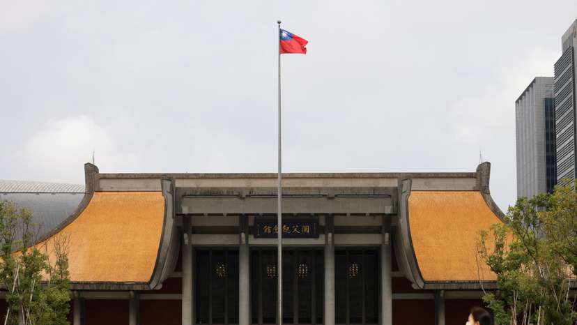 FILE PHOTO: People walk near a fluttering Taiwanese flag outside the Sun Yat-Sen Memorial Hall in Taipei