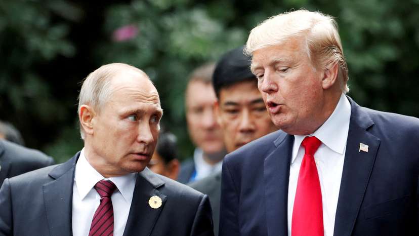FILE PHOTO: FILE PHOTO: U.S. President Donald Trump and Russia's President Vladimir Putin talk during the family photo session at the APEC Summit in Danang, Vietnam