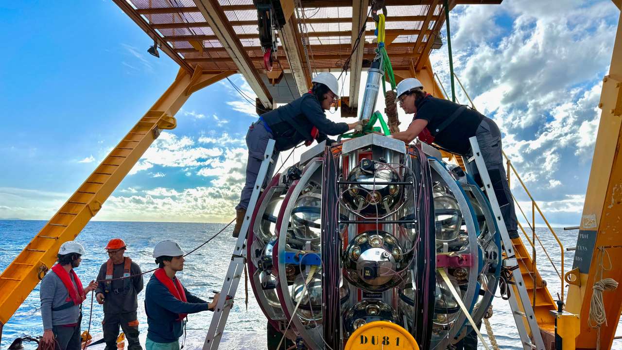 Researchers conduct final inspections on a neutrino Detection Unit (DU) aboard a research vessel to the seafloor in the Mediterranean Sea in this undated handout image