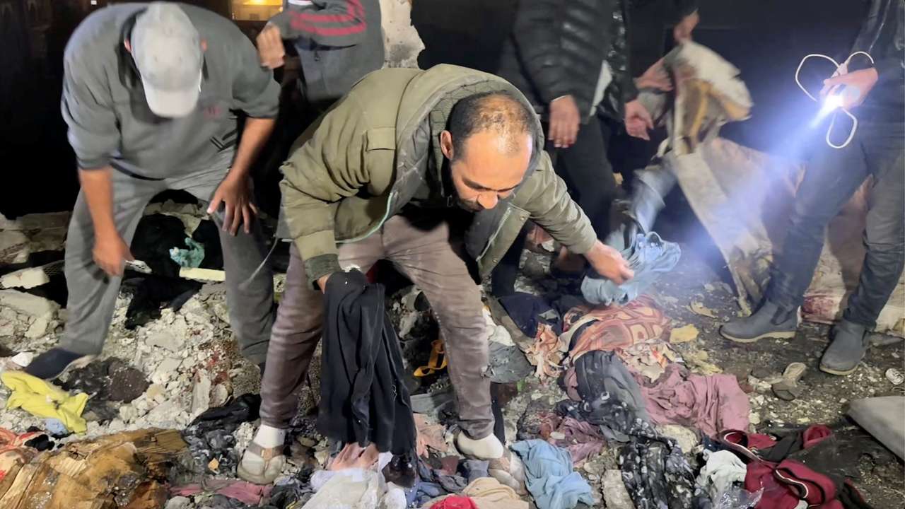 Palestinians check the site of an Israeli strike on a school sheltering displaced people, amid the Israel-Hamas conflict, in Khan Younis