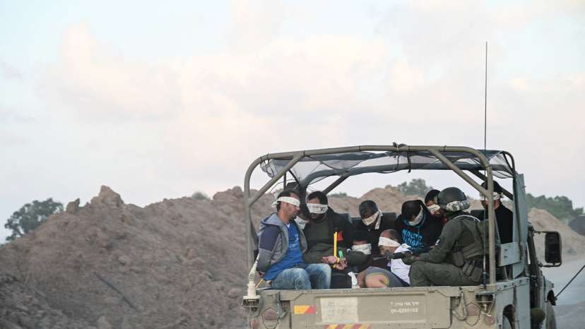 Israel's military transports Palestinian detainees from the Gaza Strip, amid the ongoing conflict between Israel and the Palestinian Islamist group Hamas, near Israel's border with Gaza