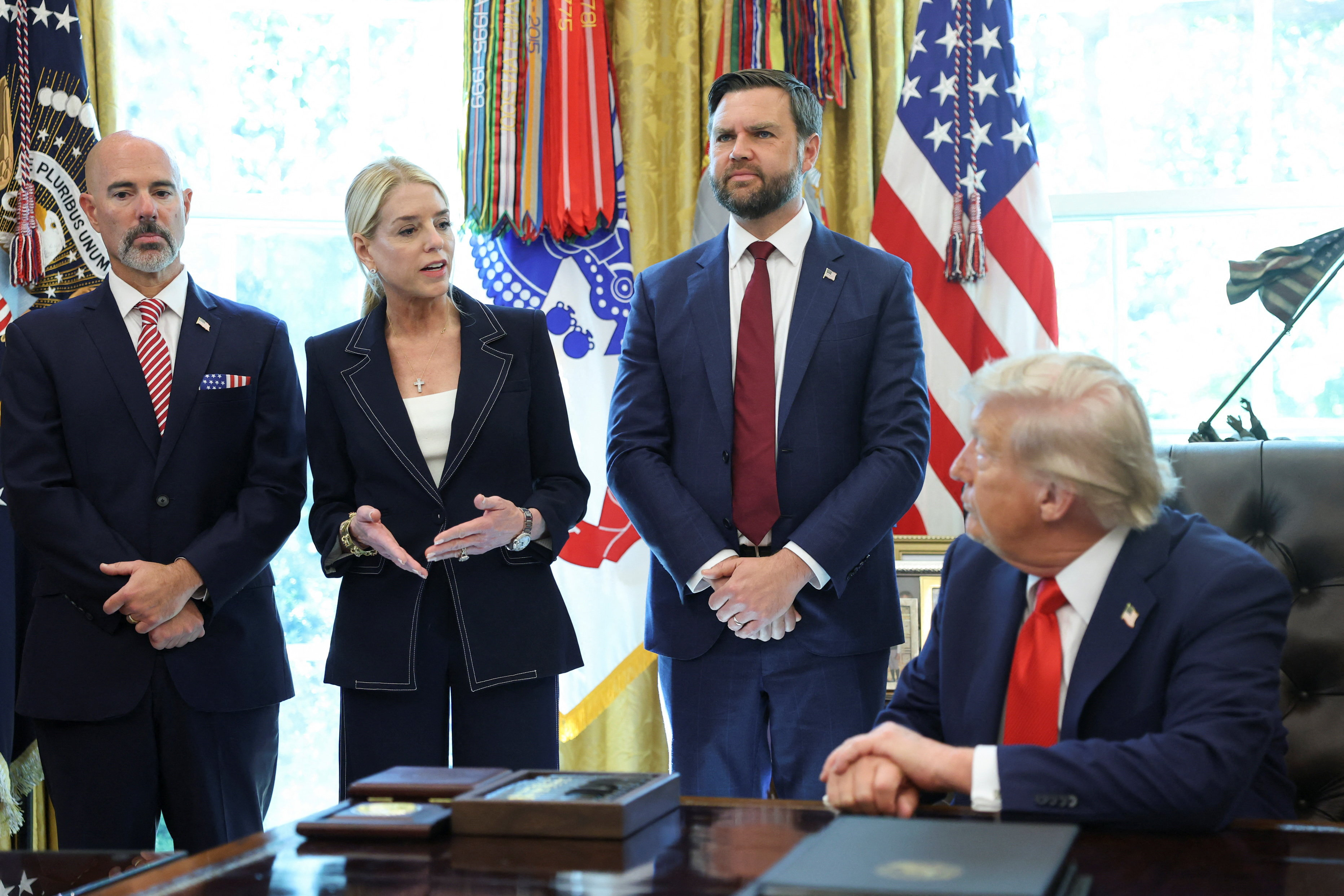 U.S. President Donald Trump signs executive orders in the Oval Office at the White House in Washington
